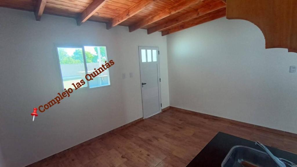 an empty room with a sign on the wall at Complejo las Quintas in Santa Teresita