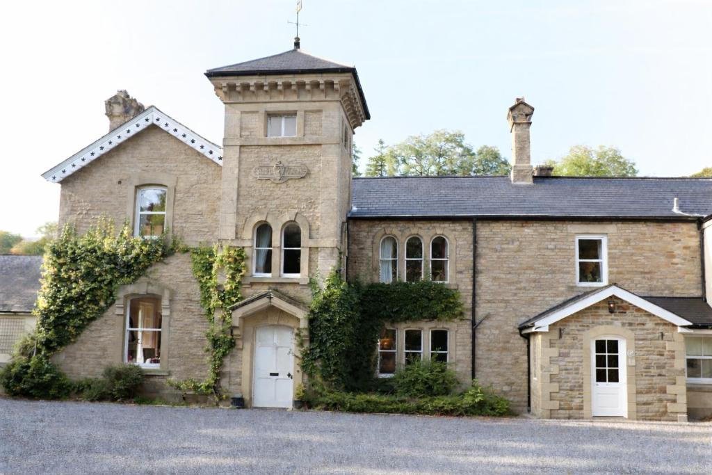 an old brick house with a tower on top at Nent Hall Country House Hotel in Nenthead
