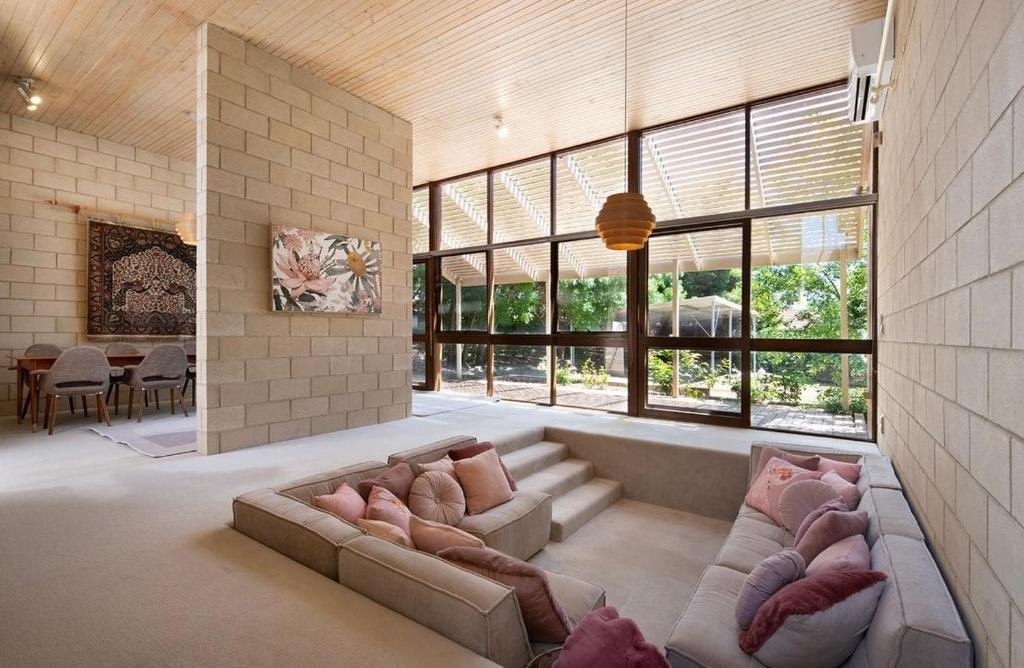 a living room with two couches and a large window at Retro Reservoir Retreat in Kennington