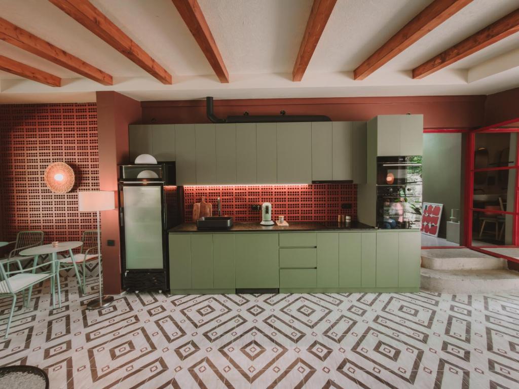 a kitchen with green cabinets and a refrigerator at Ruby Hostel, Kutaisi - Private & Shared Rooms in Kutaisi