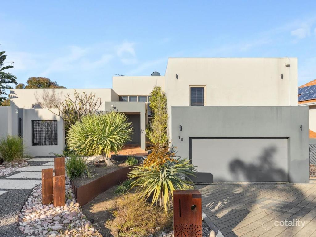 a white house with a large garage at The Studio on Barberry with a Pool in Perth