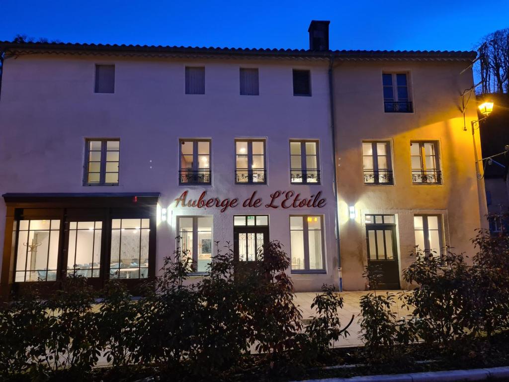 a large white building with a sign on it at Auberge de l'Etoile in Vignory
