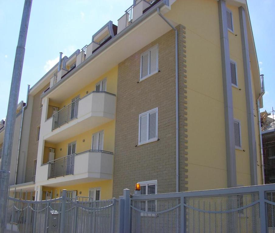a tall building with a fence in front of it at Manilù House in San Prisco