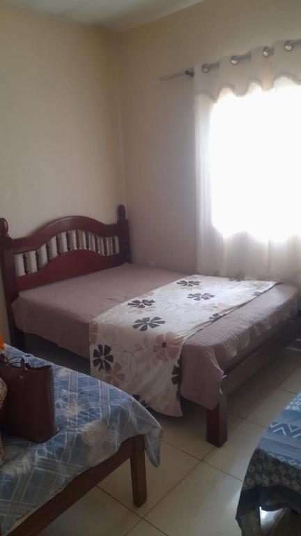 a bedroom with a bed and a window at Barbosa in Três Marias