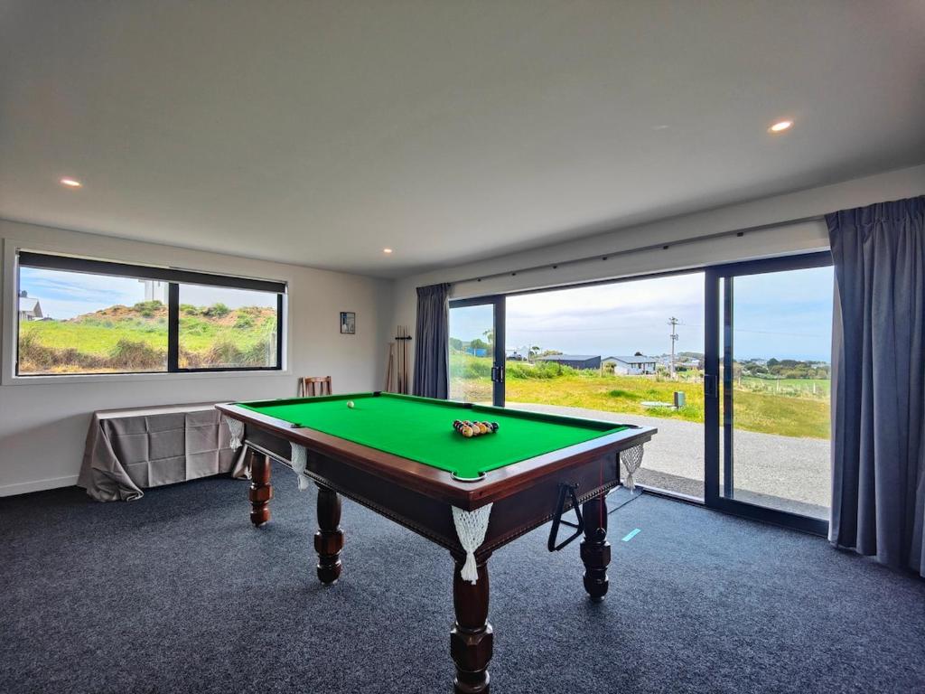 a room with a pool table in front of a window at Rack n Relax Riverton in Riverton