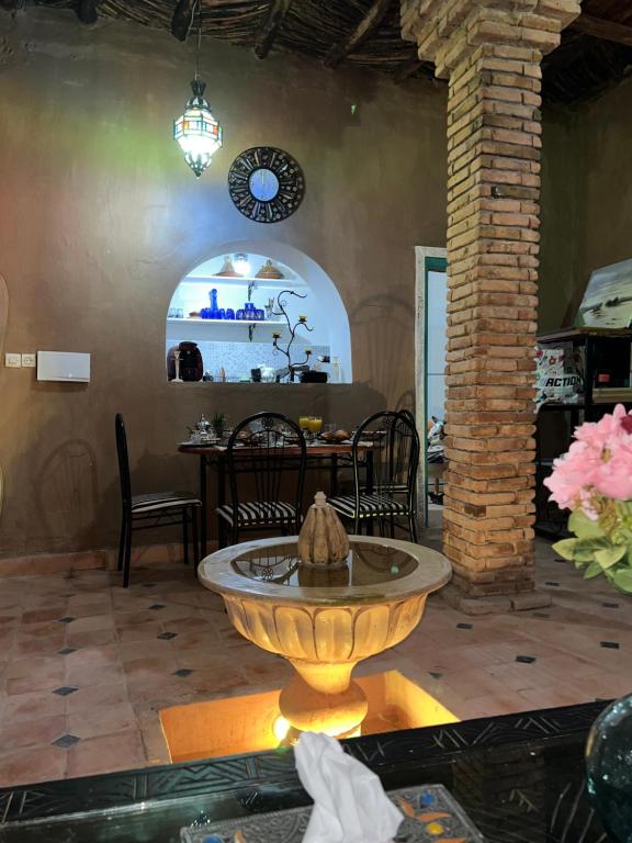 a living room with a fountain in the middle of a room at Riad Dar khadija in Taroudant