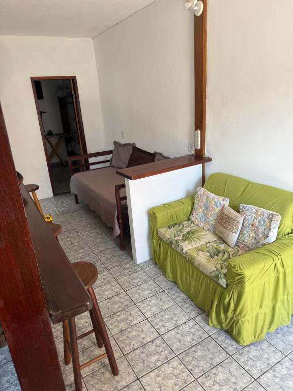 a living room with a couch and a bed at APARTAMENTO SIMPLES E ACONCHEGANTE in Paraty