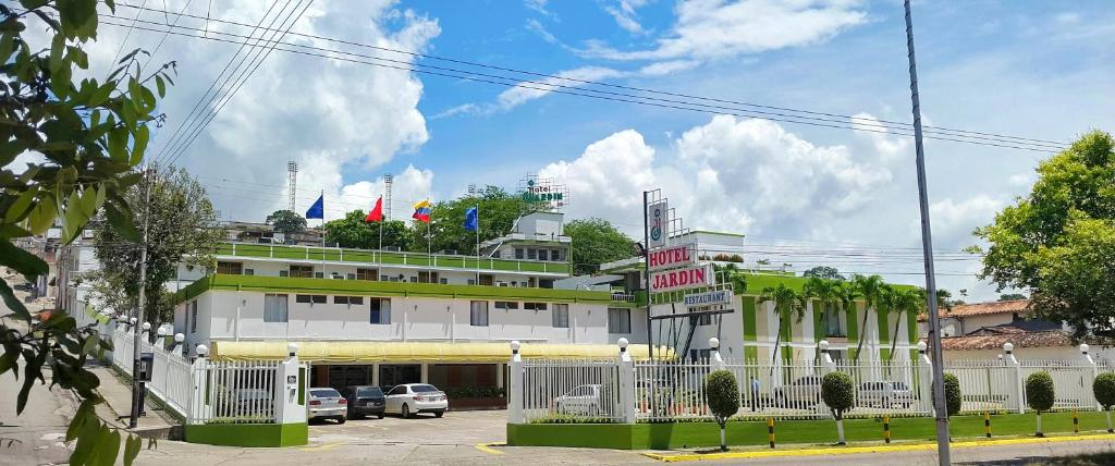 a building with cars parked in front of it at Hotel Jardin in San Cristóbal