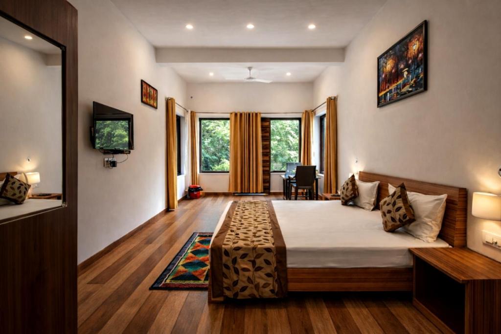 a bedroom with a bed and a tv and some windows at Bajoon homestay in Bhīm Tāl
