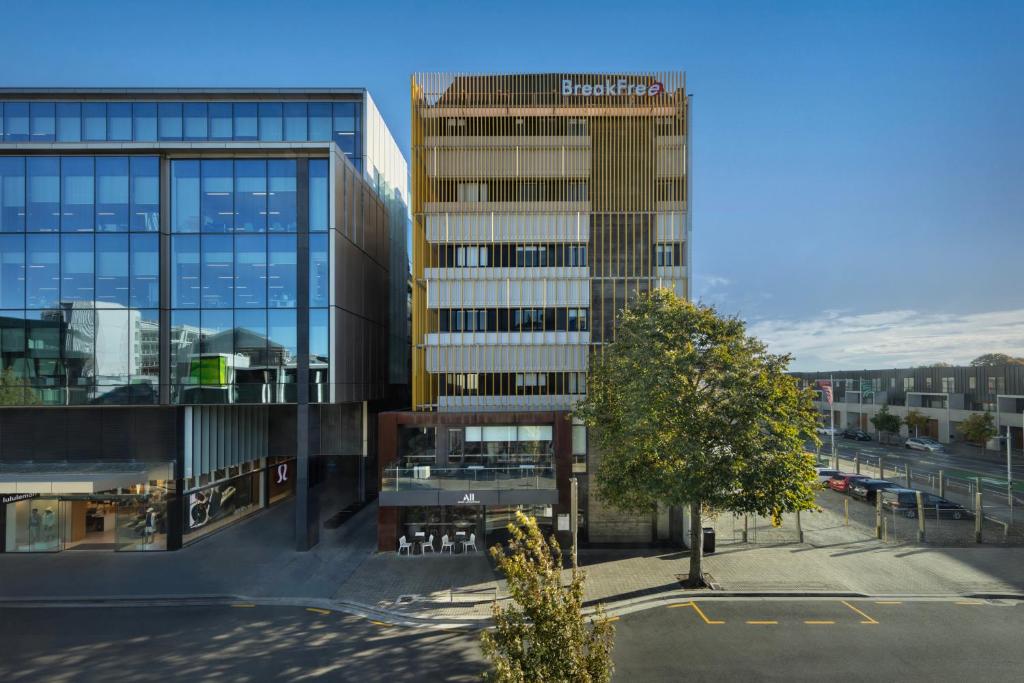 a tall glass building with a street in front of it at BreakFree on Cashel, an Accor Hotel in Christchurch