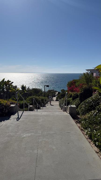 a walkway next to the ocean on a clear day at Beach Condo in Dana Point