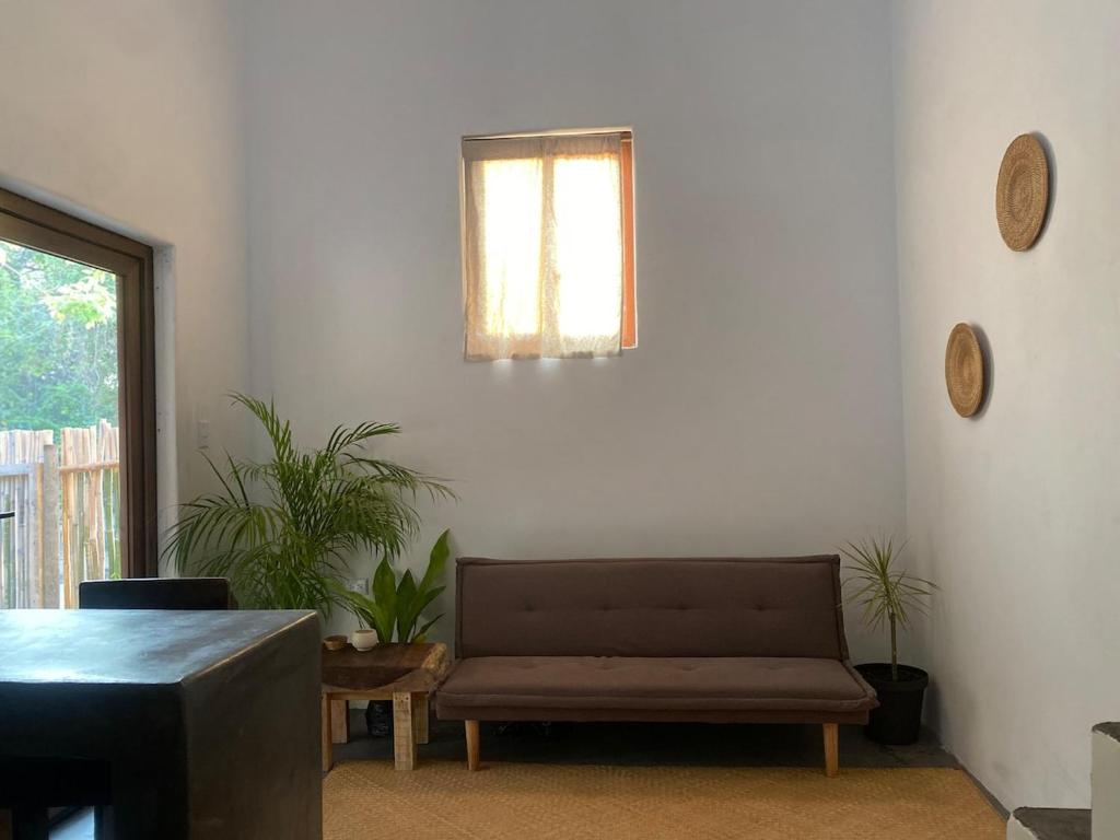 a living room with a couch and a window at Calypso Loft in El Paredón Buena Vista