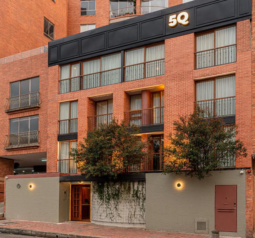 a brick building with the number on it at 5Q House Chapinero in Bogotá