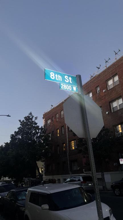 a street sign on top of a parking lot at KTown Sanctuary Soul in Los Angeles