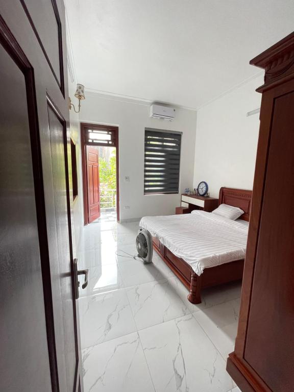 a bedroom with a bed and a window and a door at Anna's House - Hoa Lư in Ninh Binh
