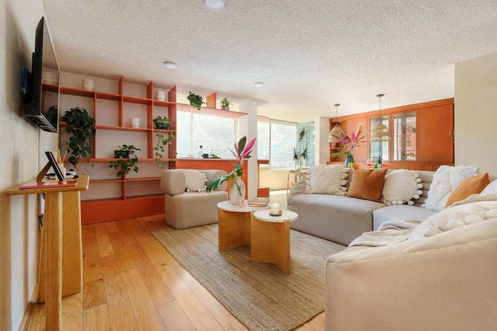 a living room with a white couch and a table at Amazing TERRAZO place, 8 guest!! 4 beds in Mexico City