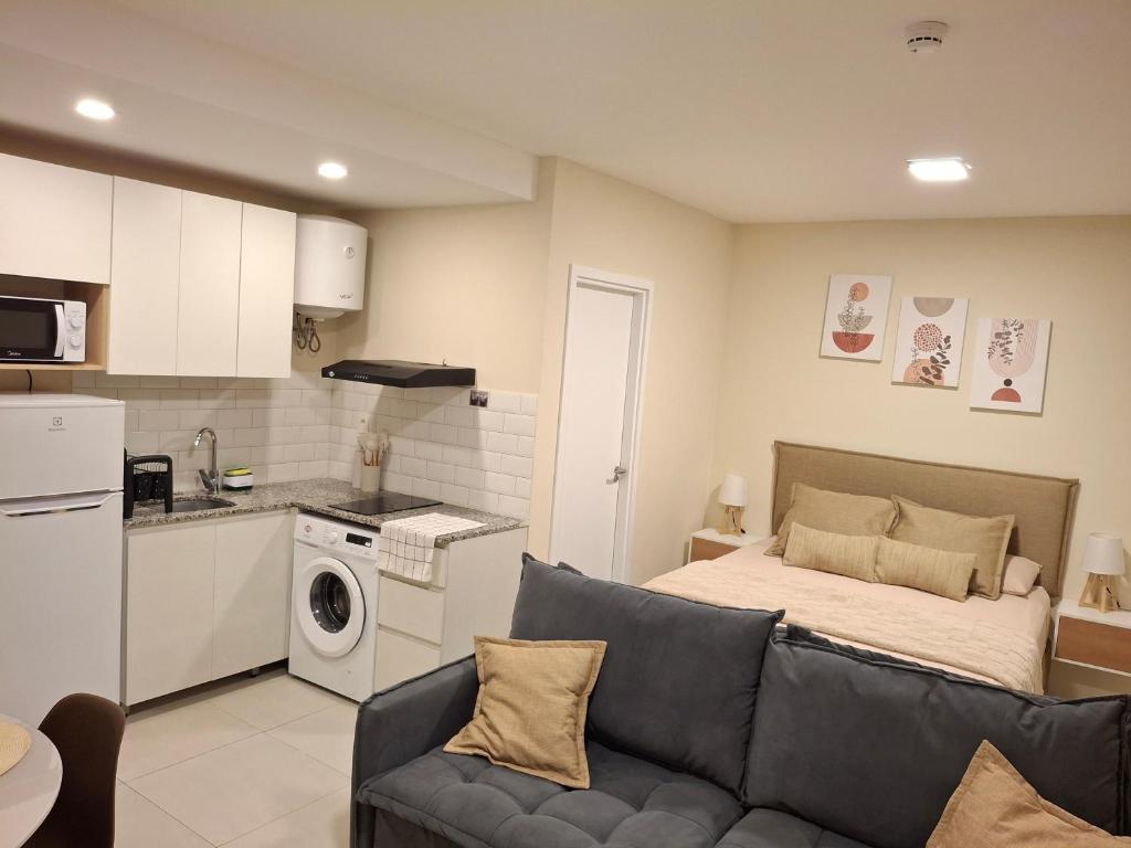 a living room with a couch and a kitchen at Dpto Resort zona aeropuerto in Luque