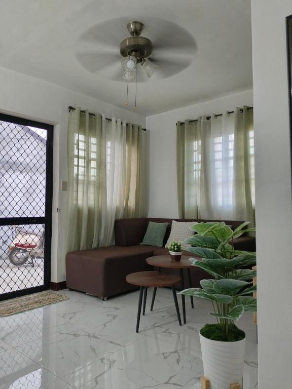 a living room with a couch and a table at Sorelle Haven II in Manolo Fortich
