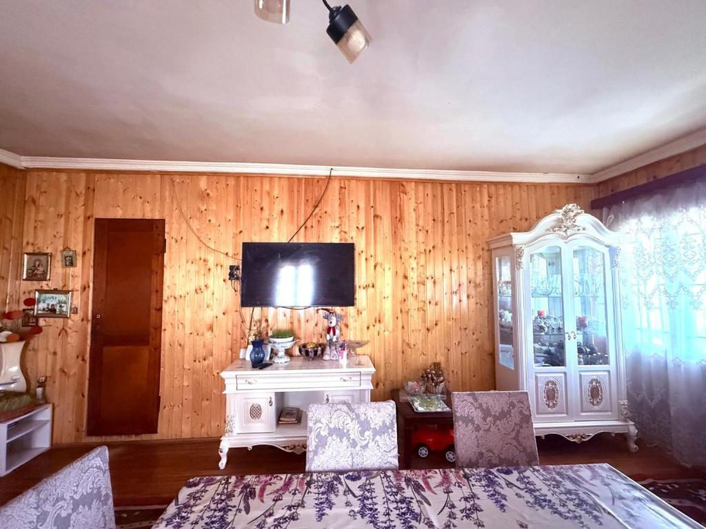 a living room with a tv and a table and chairs at BibO in Martvili