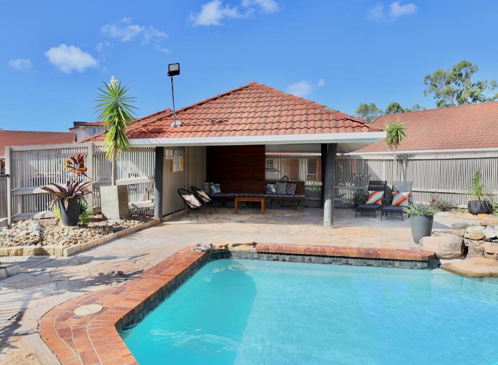 a swimming pool in the backyard of a house at Brisbane International Virginia in Brisbane