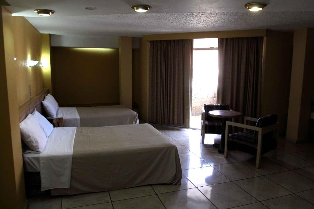 Postel nebo postele na pokoji v ubytování Hotel Universo