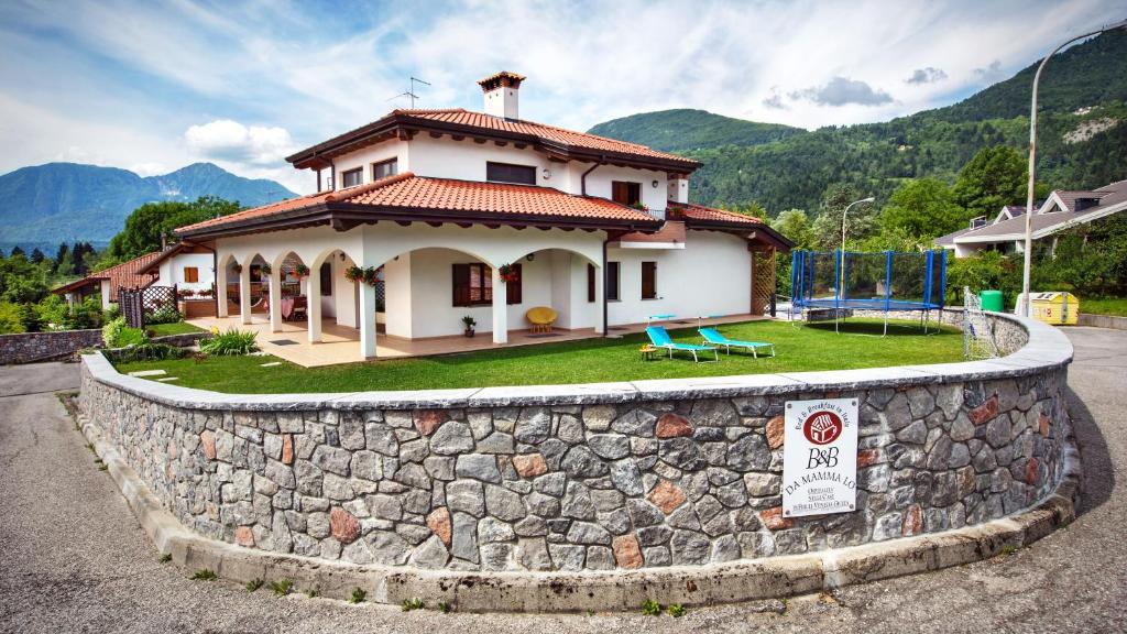 a house on top of a stone wall at B&B da mamma Lo in Tolmezzo