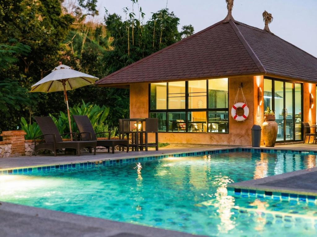 a villa with a swimming pool and a house at Katiliya Park Villa in Mae Chan
