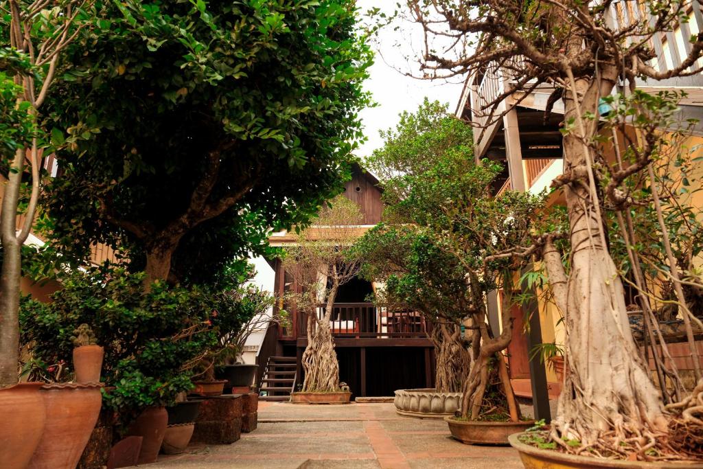 a courtyard with trees and a building at Bualuang Hotel in Luang Prabang