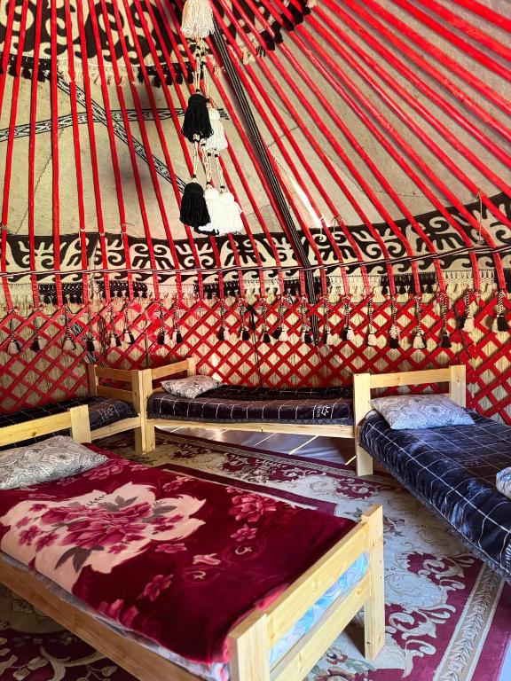 a room with two beds in a yurt at "Ethno Yurt Camp Argymak" Altyn Arashan in Mineralʼnyy Istochnik Altyn-Arasan