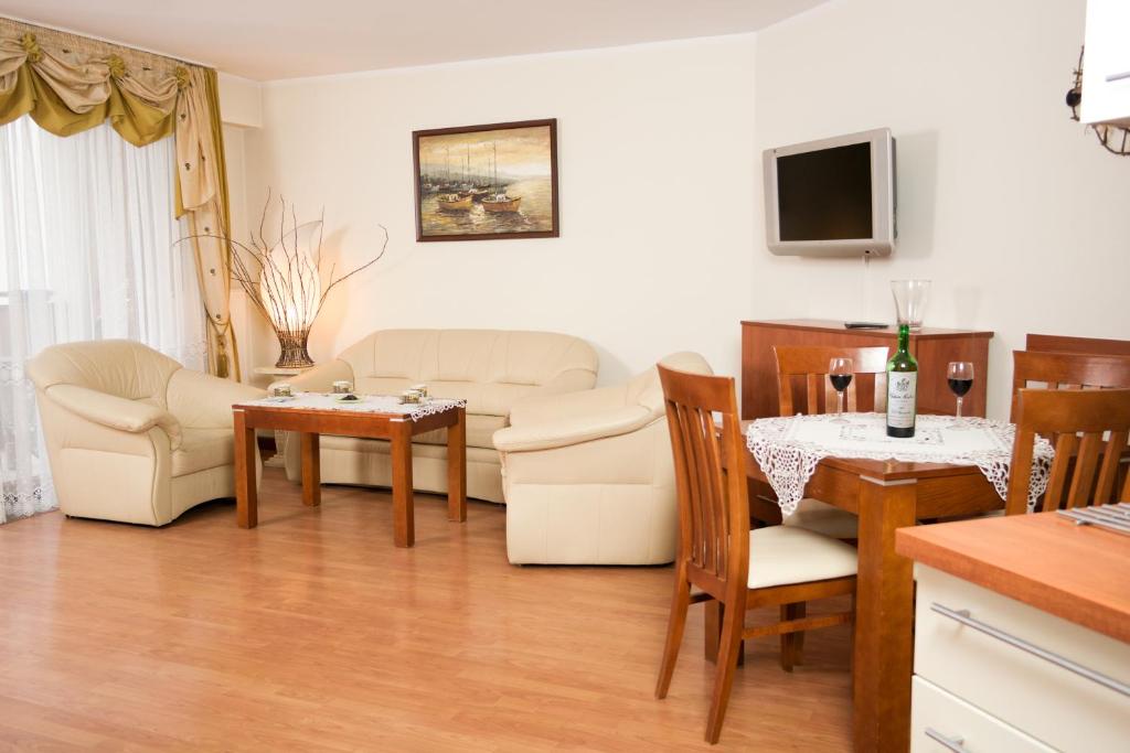 a living room with a couch and a table at Apartament blisko plaży in Władysławowo