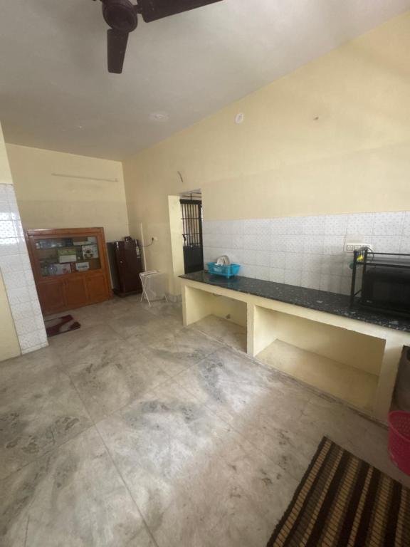 an empty room with a counter in a room at Trichy homestays in Tiruchirappalli