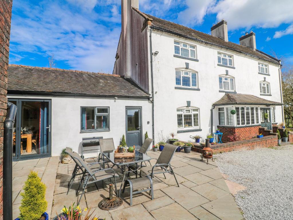 a patio in front of a white house at Fields Farm in Draycott in the Moors