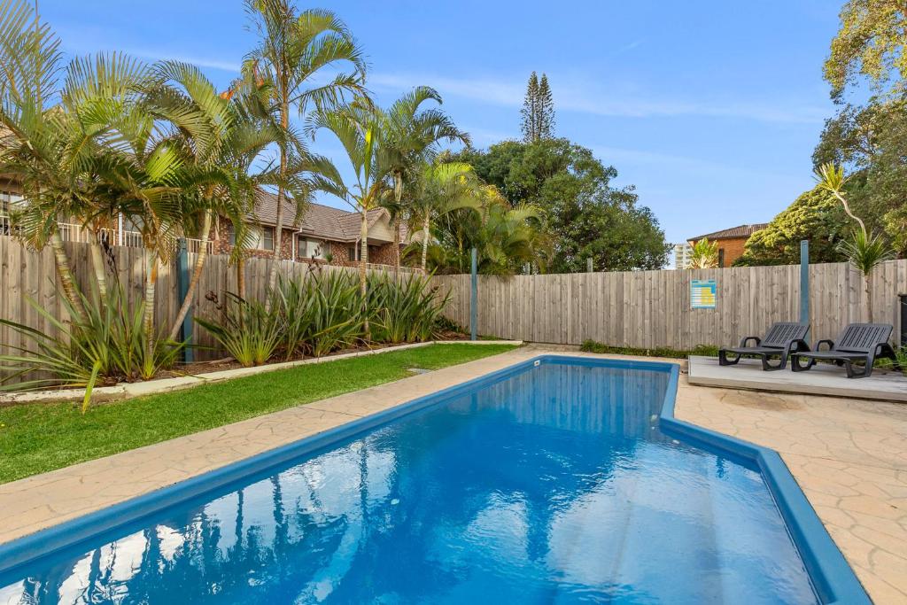 a swimming pool in a yard with a fence at Ocean Spray 5 in Coffs Harbour