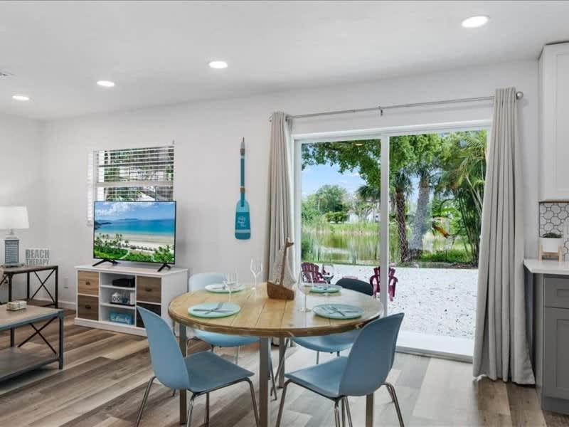 a dining room with a table and chairs and a window at Beach and Boaters Delight! in Fort Myers Beach