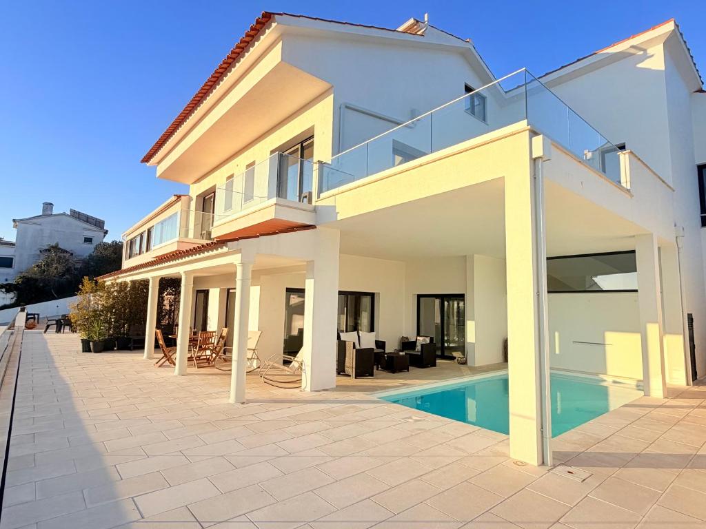 a house with a swimming pool in front of it at Vila Pombal Tomar - Luxury Apartment with private pool and Castle View in Tomar