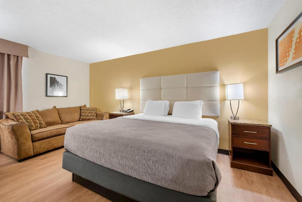 a hotel room with a bed and a couch at Quality Inn Alamosa in Alamosa