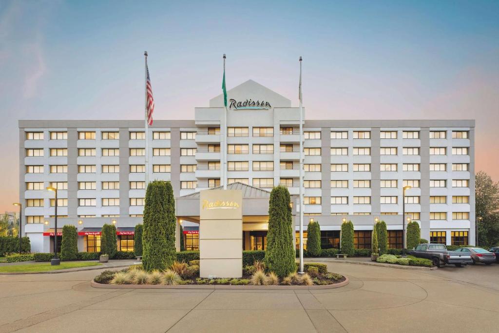 a hotel with an american flag in front of it at Radisson Hotel Seattle Airport in SeaTac