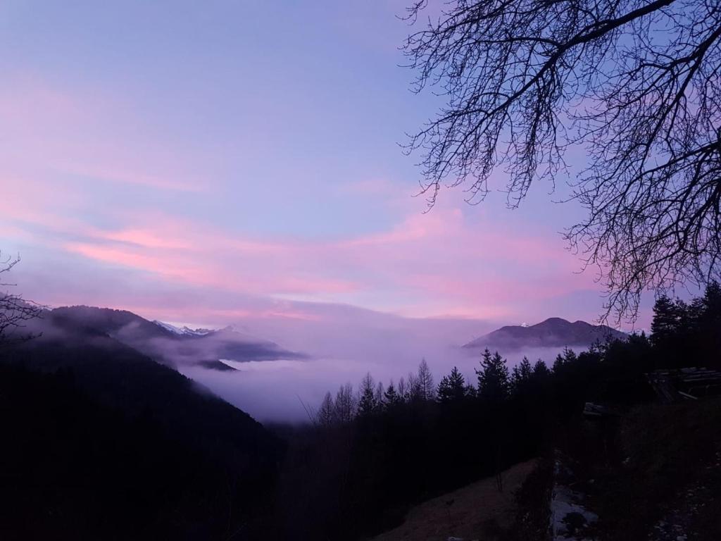 a view of a foggy valley with a mountain range at Wild mountains in La Brigue