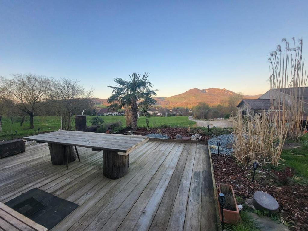 a wooden deck with a picnic table on top at Ti caz prairie in Marnoz