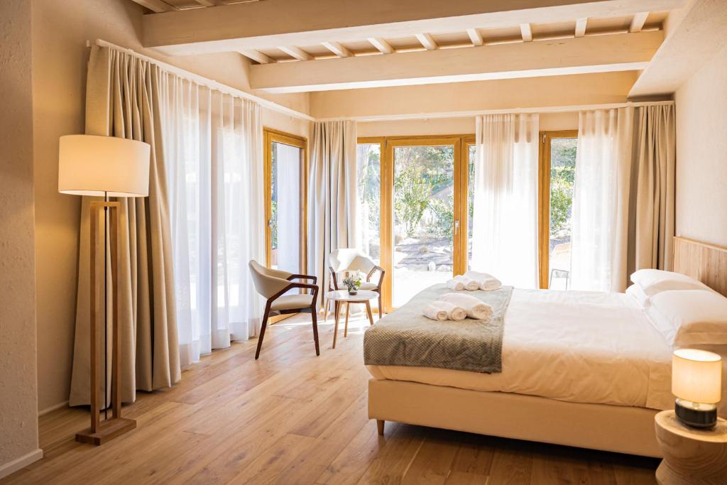a bedroom with a bed and a desk with a chair at Valle Benedetta Retreat Center in Livorno