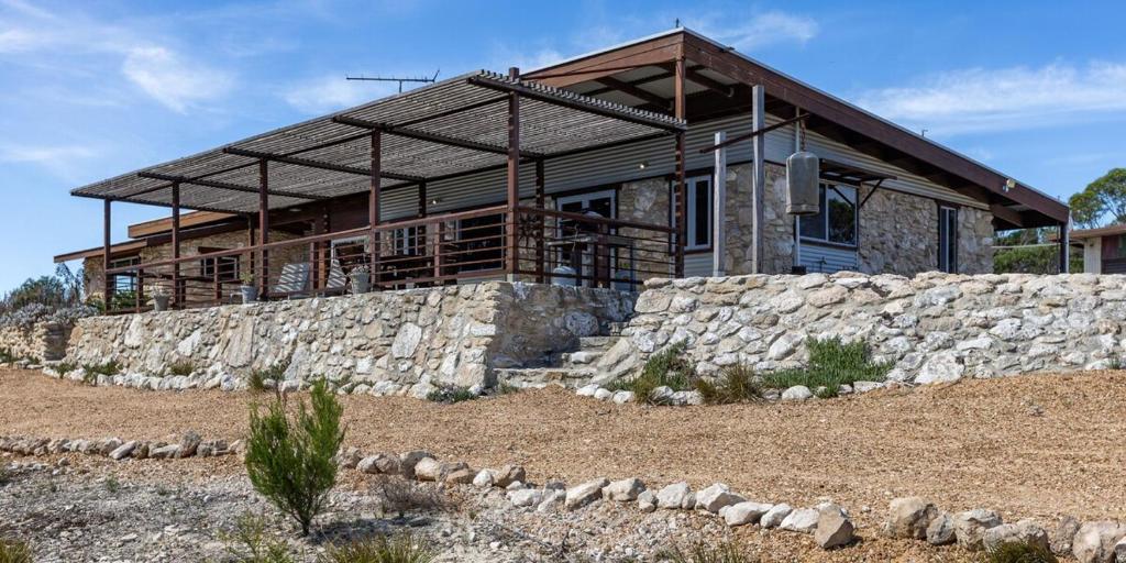 a house on top of a stone wall at Stony Rise Ranch in Pelican Lagoon