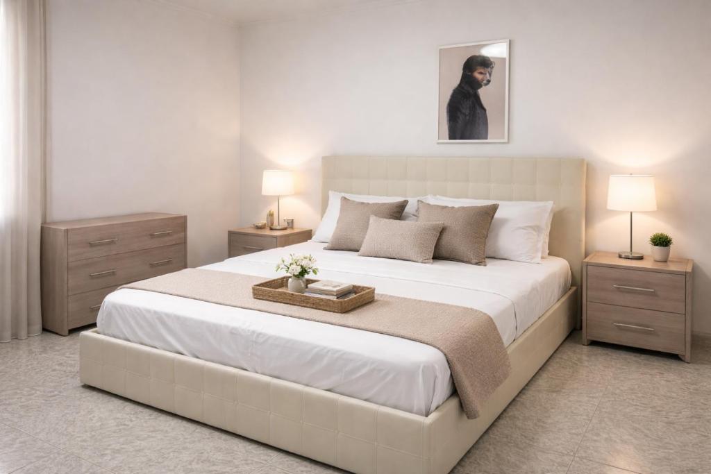 a bedroom with a large bed with a tray on it at The Urban Lodge in Bari
