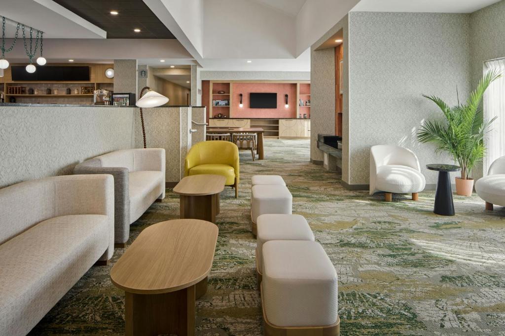 a lobby with couches and tables and a bar at Courtyard Virginia Beach Norfolk in Virginia Beach