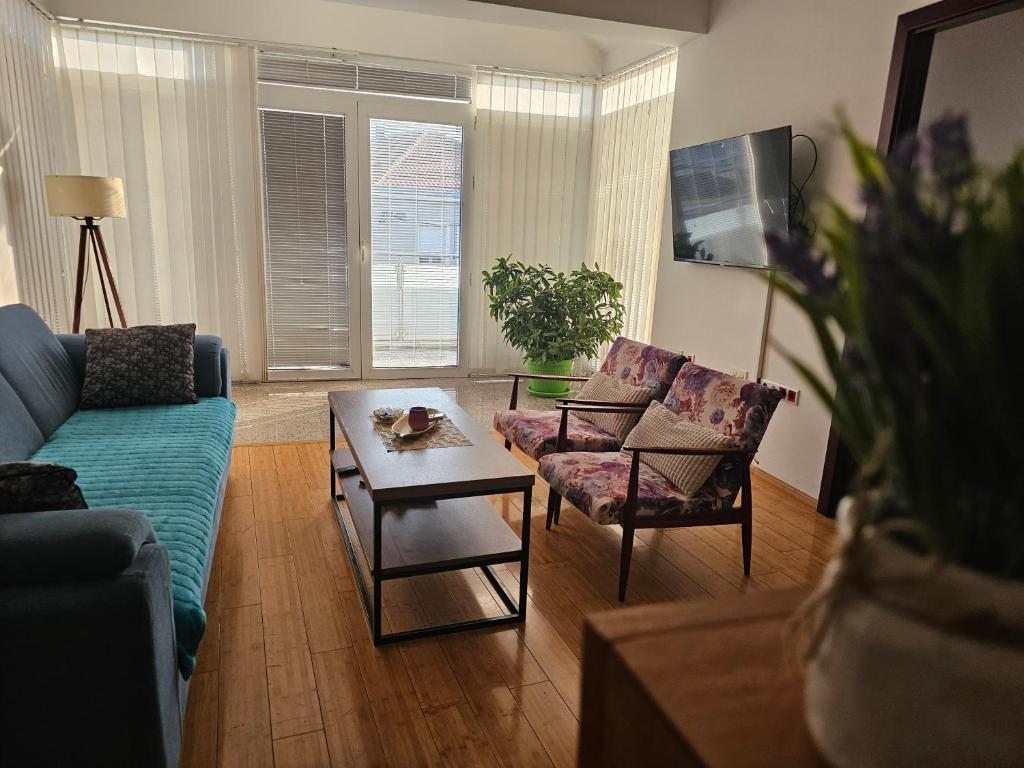 a living room with a couch and chairs and a table at Apartmani Mašić Trebinje in Trebinje