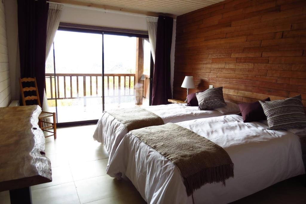 Postel nebo postele na pokoji v ubytování Kila Tai Tai Lodge