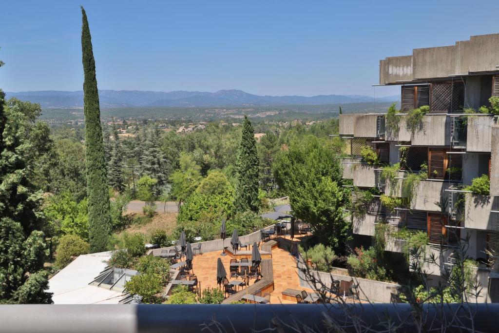 an aerial view of an apartment complex with trees at SOWELL HOTELS Ardèche in Grospierres