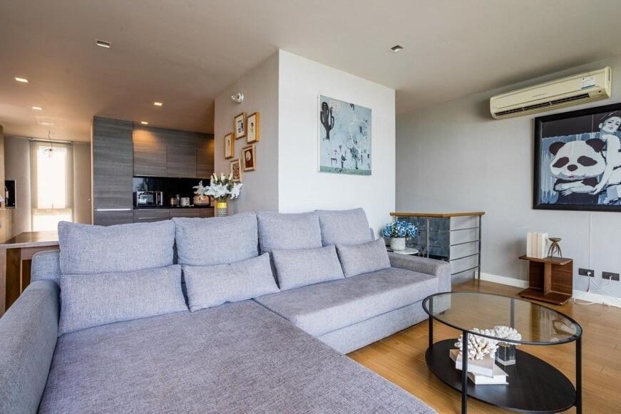 a living room with a couch and a table at Sandbox Beachfront Villa 6 in Ban Krathing Lai