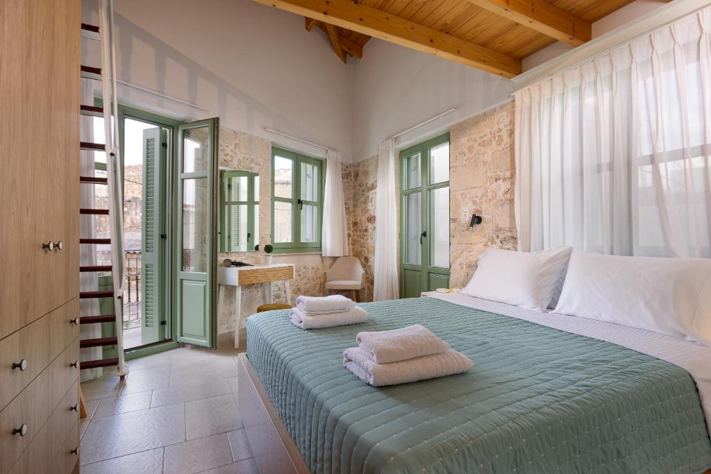 a bedroom with a bed with two towels on it at MERAKI residence in Atsipopoulo