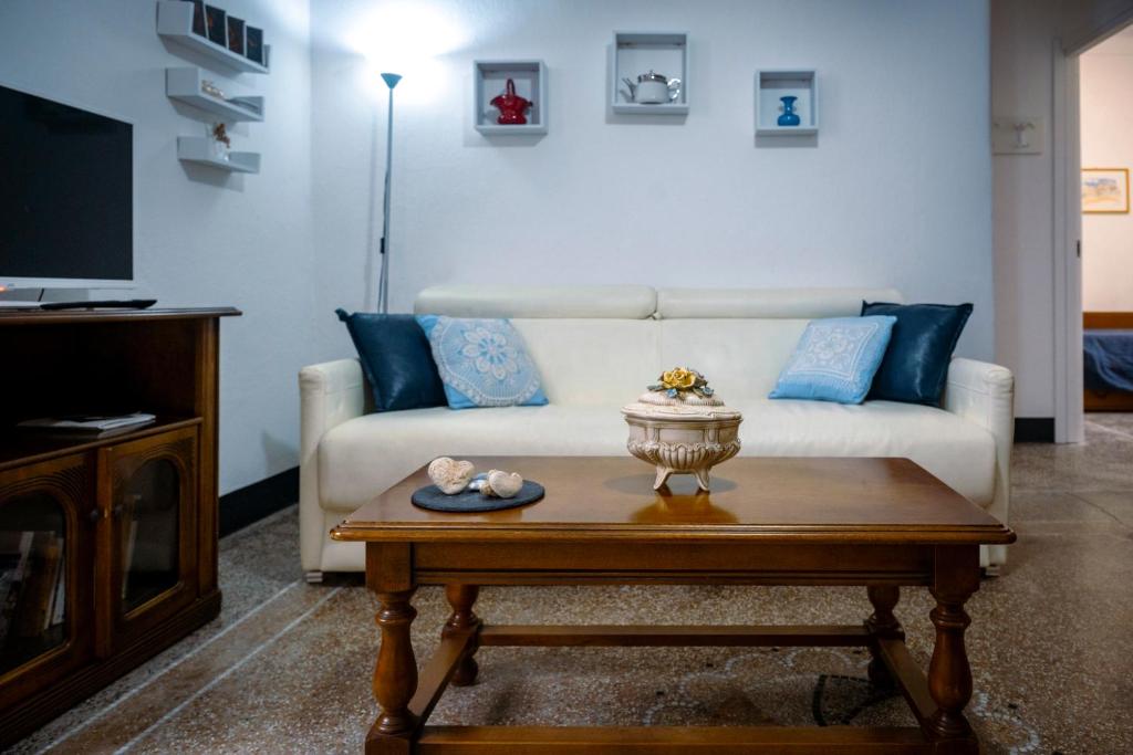 a living room with a white couch and a coffee table at La casa di Ros in Perinaldo