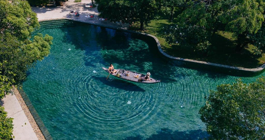 an aerial view of a boat in a body of water at Templation Hotel in Siem Reap